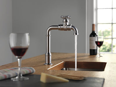 Water flowing out of Broderick Kitchen Faucet in kitchen with wine glasses on the counter