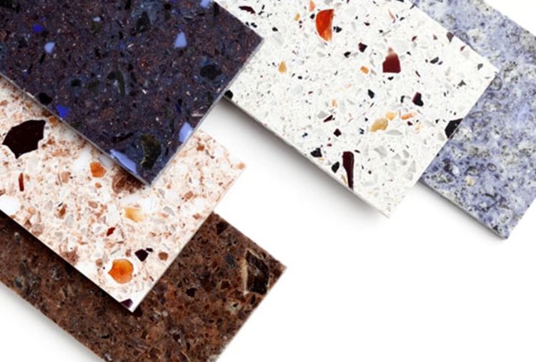 Different types of marble and granite samples on a white background