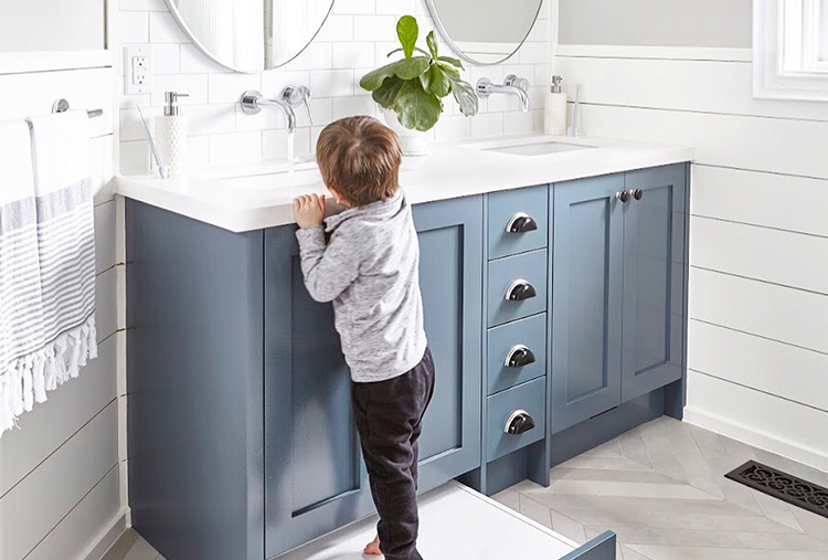 Boy reaching for faucet