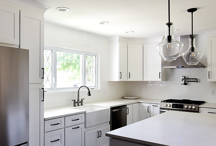 Recently remodled kitchen featuring a black stainless Broderick facuet that compliments dark hardware