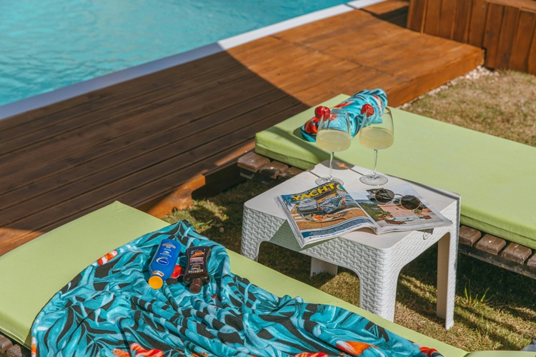 Pool chair with sunscreen and towels